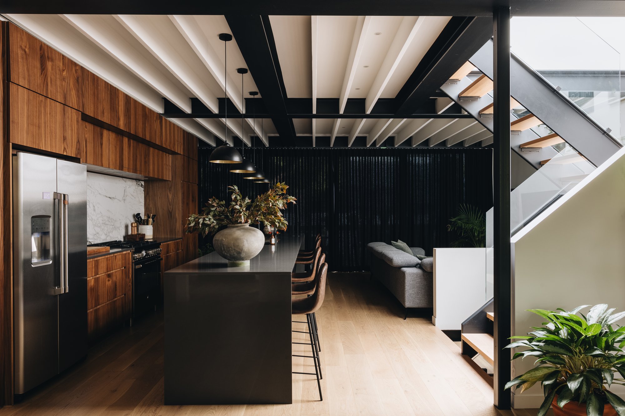 Photo of a kitchen, living room and staircase to an upper floor